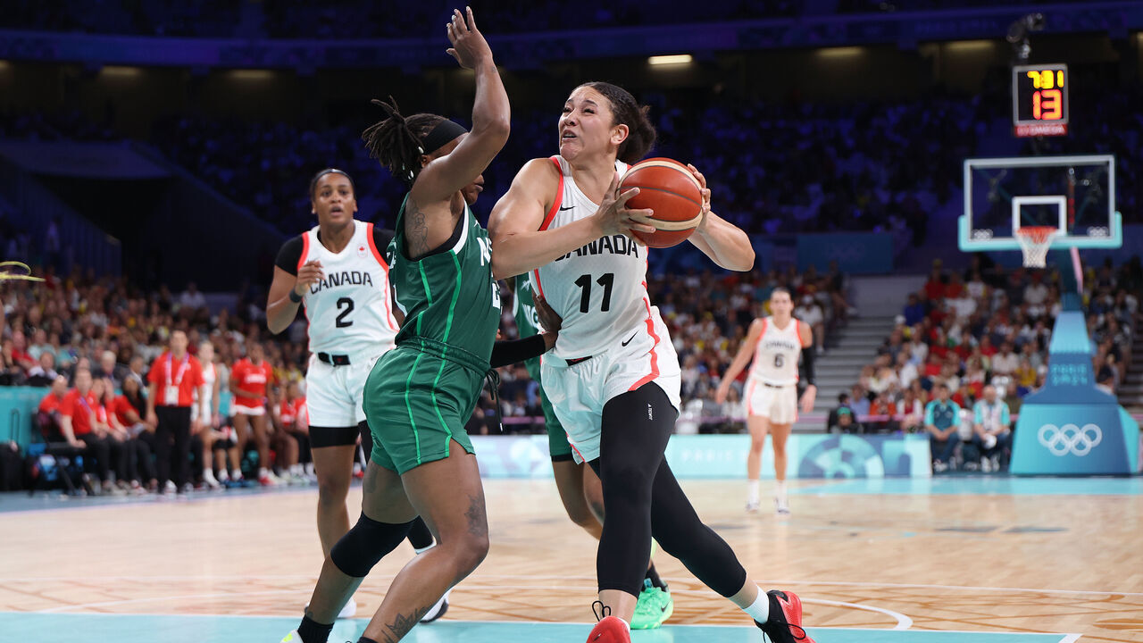 LILLE, FRANCE - AUGUST 04: Natalie Achonwa #11 of Team Canada drives to the basket during the Women's Group Phase - Group match between of Team Canada and Team Nigeria on day nine of the Olympic Games Paris 2024 at Pierre Mauroy Stadium on August 04, 2024 in Lille, France.