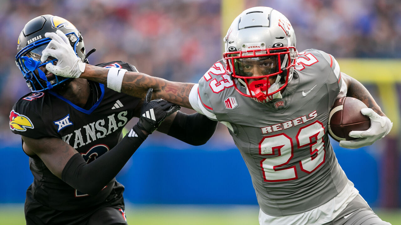 KANSAS CITY, KS - SEPTEMBER 13: UNLV defensive back Saadite Green Jr. (23) stiff arms Kansas cornerback Cobee Bryant (2) during the game between the Kansas Jayhawks and the UNLV Rebels on Friday September 13, 2024 at Children's Mercy Park in Kansas City, Kansas.