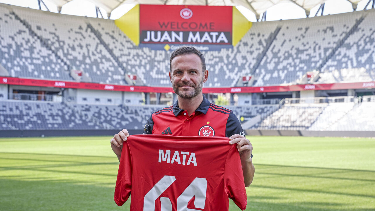 Spain's Juan Mata stands with a Western Sydney Wanderers jersey after a press conference at CommBank Stadium in Sydney on September 14, 2024. The former Spain international has signed a deal to play in Australia with the A-League football club Western Sydney Wanderers.
