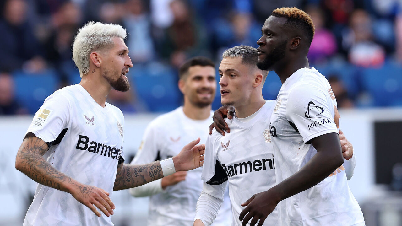 SINSHEIM, GERMANY - SEPTEMBER 14: Florian Wirtz of Bayer 04 Leverkusen celebrates scoring his team's third goal from the penalty spot with team mates Robert Andrich and Victor Boniface of Bayer 04 Leverkusen during the Bundesliga match between TSG 1899 Hoffenheim and Bayer 04 Leverkusen at PreZero-Arena on September 14, 2024 in Sinsheim, Germany.
