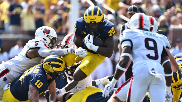ANN ARBOR, MI - SEPTEMBER 14: Michigan Wolverines running back Kalel Mullings (20) jumps over the line for a first down during the Michigan Wolverines versus the Arkansas State Red Wolves game on Saturday September 14, 2024 at Michigan Stadium in Ann Arbor, MI.