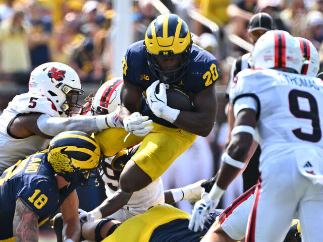 ANN ARBOR, MI - SEPTEMBER 14: Michigan Wolverines running back Kalel Mullings (20) jumps over the line for a first down during the Michigan Wolverines versus the Arkansas State Red Wolves game on Saturday September 14, 2024 at Michigan Stadium in Ann Arbor, MI.
