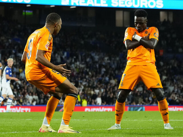 Kylian Mbappe centre-forward of Real Madrid and France celebrates with Vinicius Junior left winger of Real Madrid and Brazil after scoring his sides first goal during the La Liga match between Real Sociedad de Fútbol and Real Madrid CF at Reale Arena on September 15, 2024 in San Sebastian, Spain.