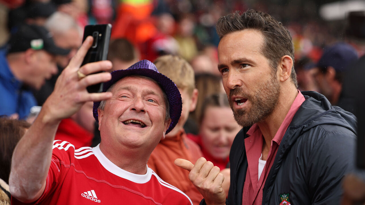 WREXHAM, WALES - AUGUST 5: Ryan Reynolds the co-owner of Wrexham greets the fans prior to Wrexham's first game back in the football league prior to the Sky Bet League Two match between Wrexham and Milton Keynes Dons at Racecourse Ground on August 5, 2023 in Wrexham, Wales.
