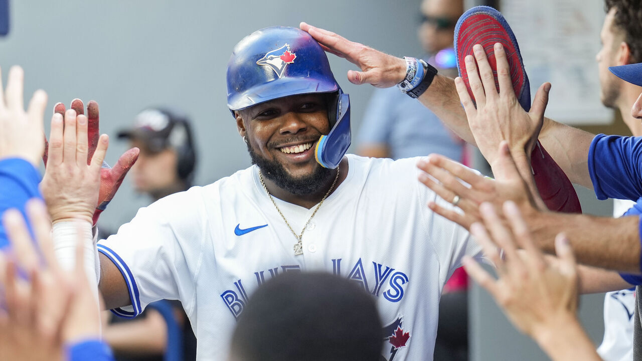 TORONTO, ON - SEPTEMBER 14: Vladimir Guerrero Jr. #27 of the Toronto Blue Jays celebrates scoring in the dugout against the St. Louis Cardinals during the seventh inning in their MLB game at the Rogers Centre on September 14, 2024 in Toronto, Ontario, Canada.