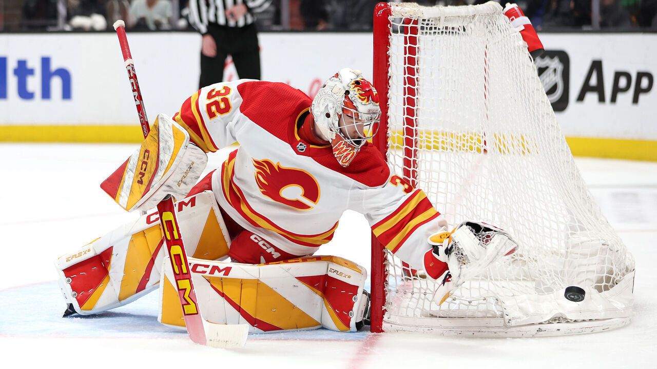 ANAHEIM, CALIFORNIA - APRIL 12: Dustin Wolf #32 of the Calgary Flames pushes off a puck during the second period of a game against the Calgary Flames at Honda Center on April 12, 2024 in Anaheim, California.