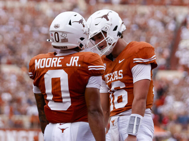 AUSTIN, TX - SEPTEMBER 14: Texas Longhorns quarterback Arch Manning (16)(R) celebrates with Texas Longhorns wide receiver DeAndre Moore Jr. (0)(L) after Moore scores a touchdown during the first half of the game against the UTSA Roadrunners on September 14, 2024, at Darrell K Royal - Texas Memorial Stadium in Austin, TX.