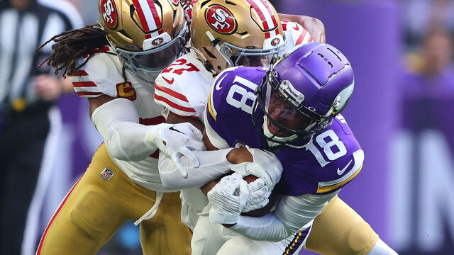 MINNEAPOLIS, MINNESOTA - SEPTEMBER 15: Yetur Gross-Matos #94 and Ji'Ayir Brown #27 of the San Francisco 49ers tackle Justin Jefferson #18 of the Minnesota Vikings during the first quarter at U.S. Bank Stadium on September 15, 2024 in Minneapolis, Minnesota.
