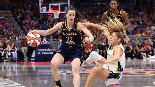 INDIANAPOLIS, INDIANA - SEPTEMBER 15: Caitlin Clark #22 of the Indiana Fever drives to the basket against Jacy Sheldon #4 of the Dallas Wings during the second half at Gainbridge Fieldhouse on September 15, 2024 in Indianapolis, Indiana.