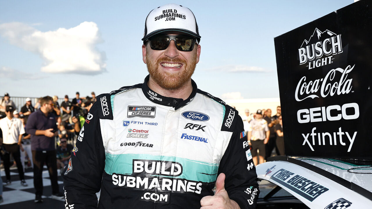WATKINS GLEN, NEW YORK - SEPTEMBER 15: Chris Buescher, driver of the #17 BuildSubmarines.com Ford, poses with the winner sticker on his car in victory lane after winning the NASCAR Cup Series Go Bowling at The Glen at Watkins Glen International on September 15, 2024 in Watkins Glen, New York.