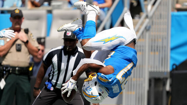 CHARLOTTE, NORTH CAROLINA - SEPTEMBER 15: J.K. Dobbins #27 of the Los Angeles Chargers flips into the end zone for a second quarter touchdown against the Carolina Panthers at Bank of America Stadium on September 15, 2024 in Charlotte, North Carolina.