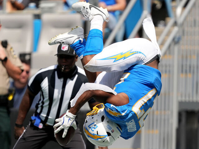 CHARLOTTE, NORTH CAROLINA - SEPTEMBER 15: J.K. Dobbins #27 of the Los Angeles Chargers flips into the end zone for a second quarter touchdown against the Carolina Panthers at Bank of America Stadium on September 15, 2024 in Charlotte, North Carolina.