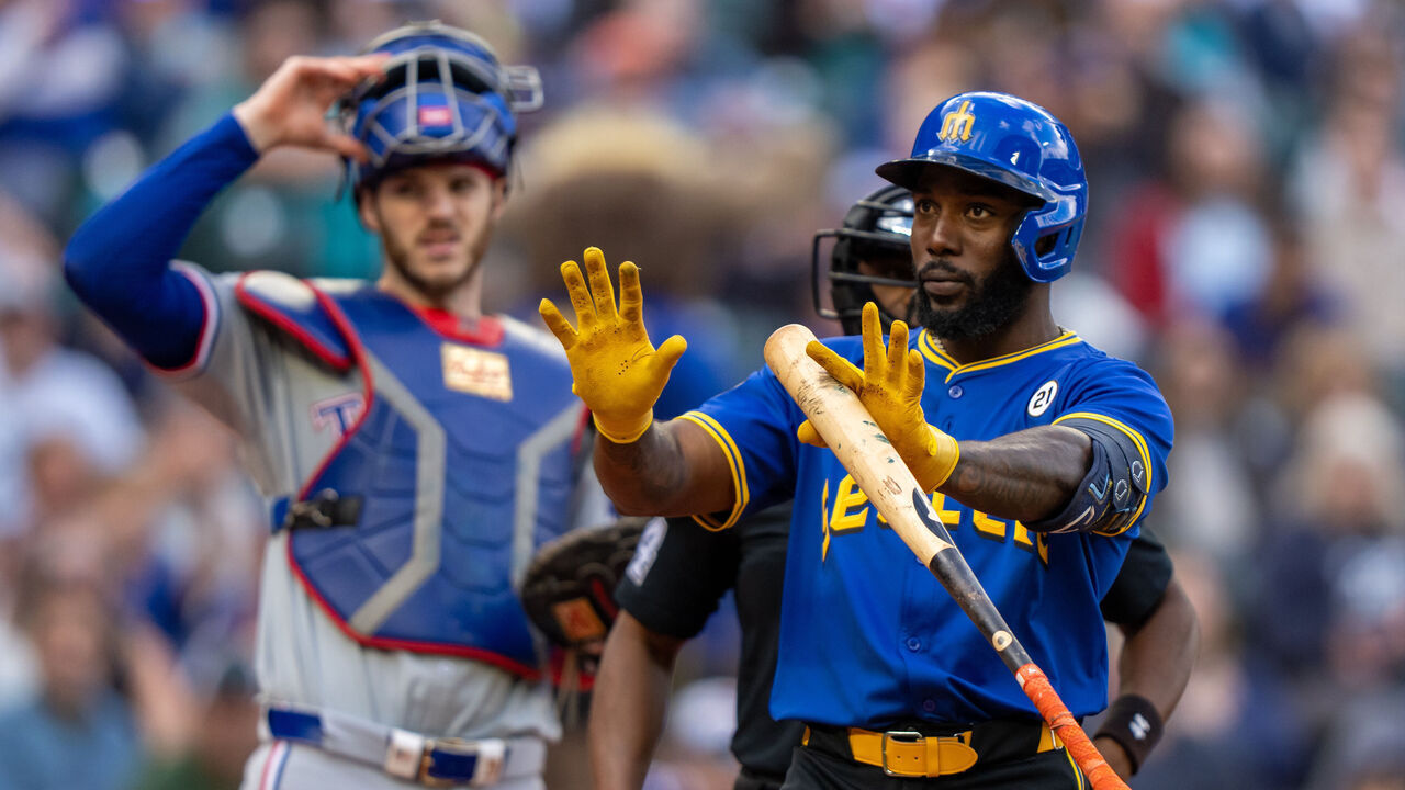 SEATTLE, WA - SEPTEMBER 15: Randy Arozarena #56 of the Seattle Mariners gestures to his dugout after being hit by a pitch during the eighth inning of a game against the Texas Rangers at T-Mobile Park on September 15, 2024 in Seattle, Washington. Many players are wearing #21 in honor of Roberto Clemente Day.