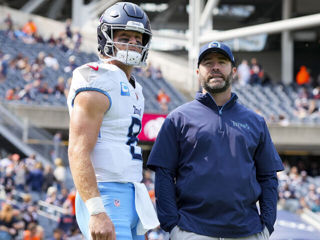 CHICAGO, IL - SEPTEMBER 8: Quarterback Will Levis #8 of the Tennessee Titans and head coach Brian Callahan stand on the field prior to an NFL football game against the Chicago Bears, at Soldier Field on September 8, 2024 in Chicago, Illinois.