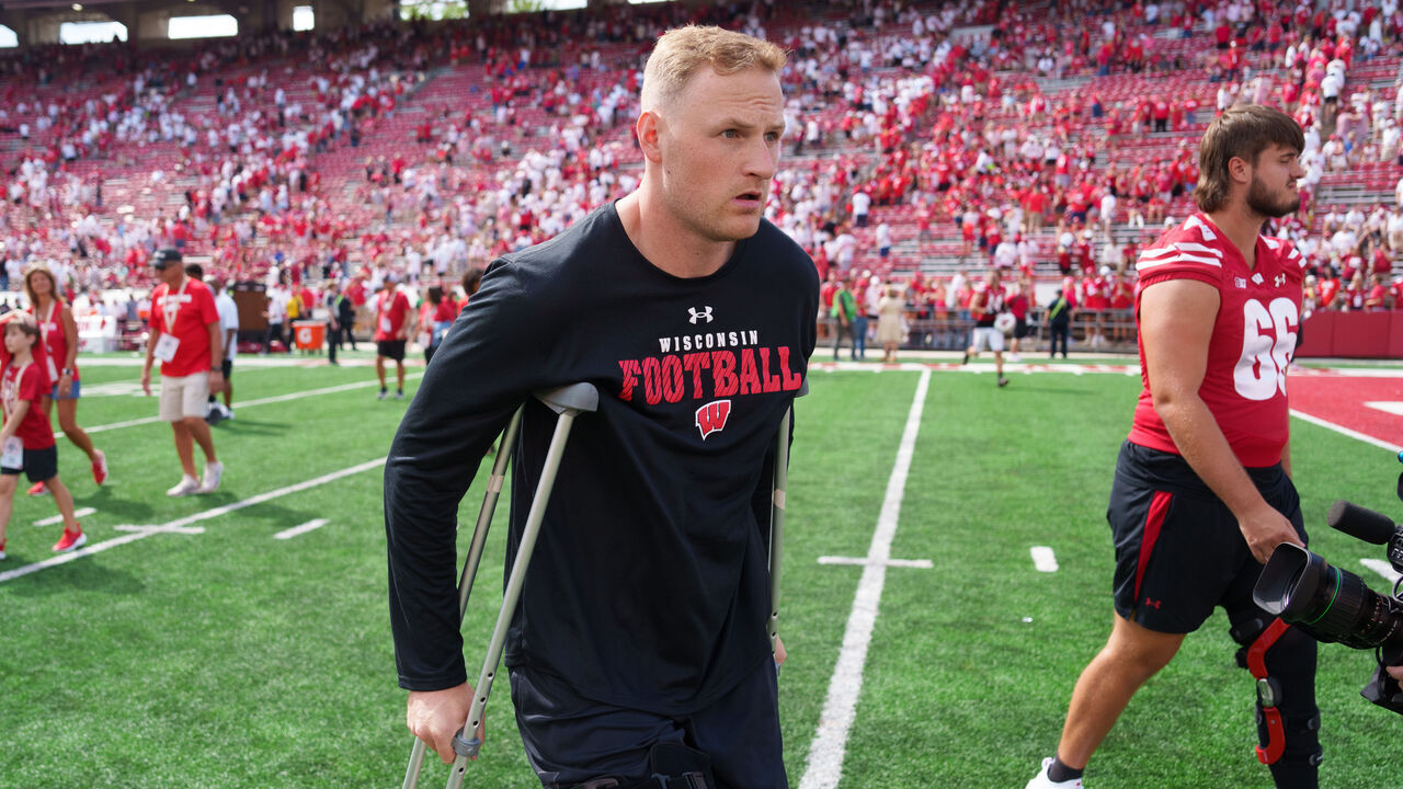 MADISON, WISCONSIN - SEPTEMBER 14: Quarterback Tyler Van Dyke #10 of the Wisconsin Badgers walks off the field using crutches following an NCAA college football game against the Alabama Crimson Tide at Camp Randall Stadium on September 14, 2024 in Madison, Wisconsin.