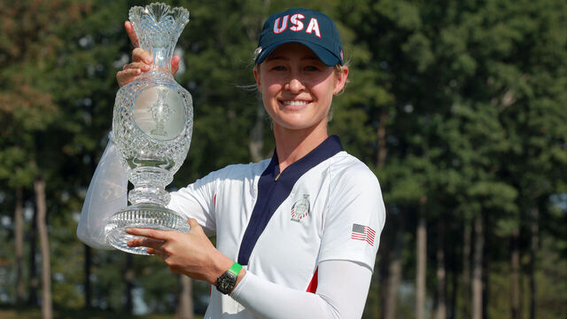 GAINESVILLE, VIRGINIA - SEPTEMBER 15: Nelly Korda of the United States poses with her caddie while holding the trophy after a Team USA win at the conclusion of the Solheim Cup at Robert Trent Jones Golf Club on Sunday, September 15, 2024 in Gainesville, Virginia.