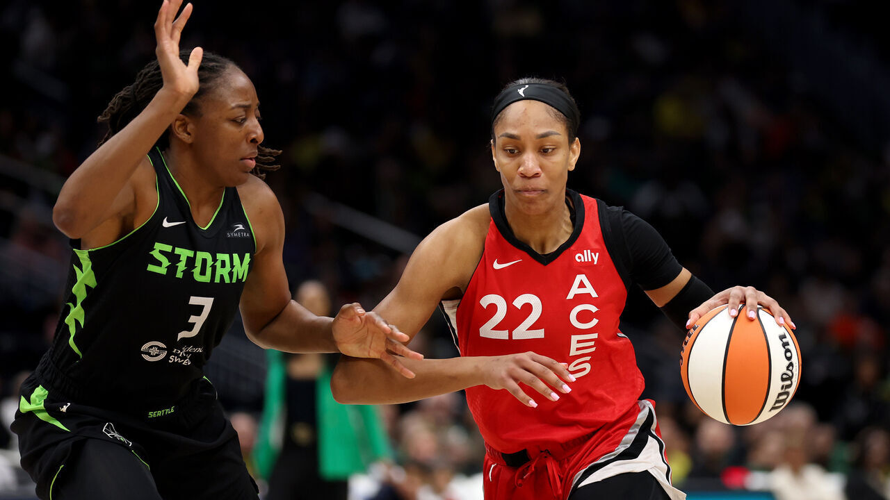 SEATTLE, WASHINGTON - SEPTEMBER 17: A'ja Wilson #22 of the Las Vegas Aces drives to the hoop against Nneka Ogwumike #3 of the Seattle Storm during the third quarter at Climate Pledge Arena on September 17, 2024 in Seattle, Washington.