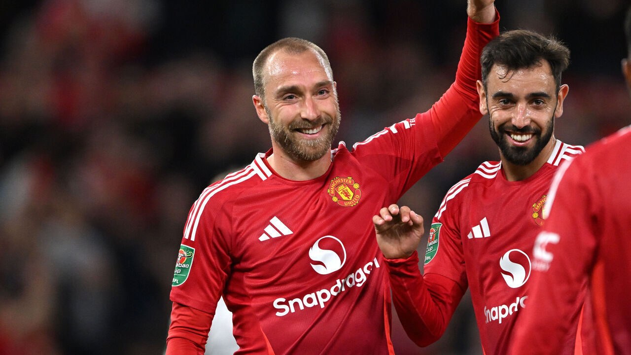 MANCHESTER, ENGLAND - SEPTEMBER 17: Christian Eriksen of Manchester United celebrates scoring his team's sixth goal with teammates Bruno Fernandes and Amad during the Carabao Cup Third Round match between Manchester United and Barnsley at Old Trafford on September 17, 2024 in Manchester, England.