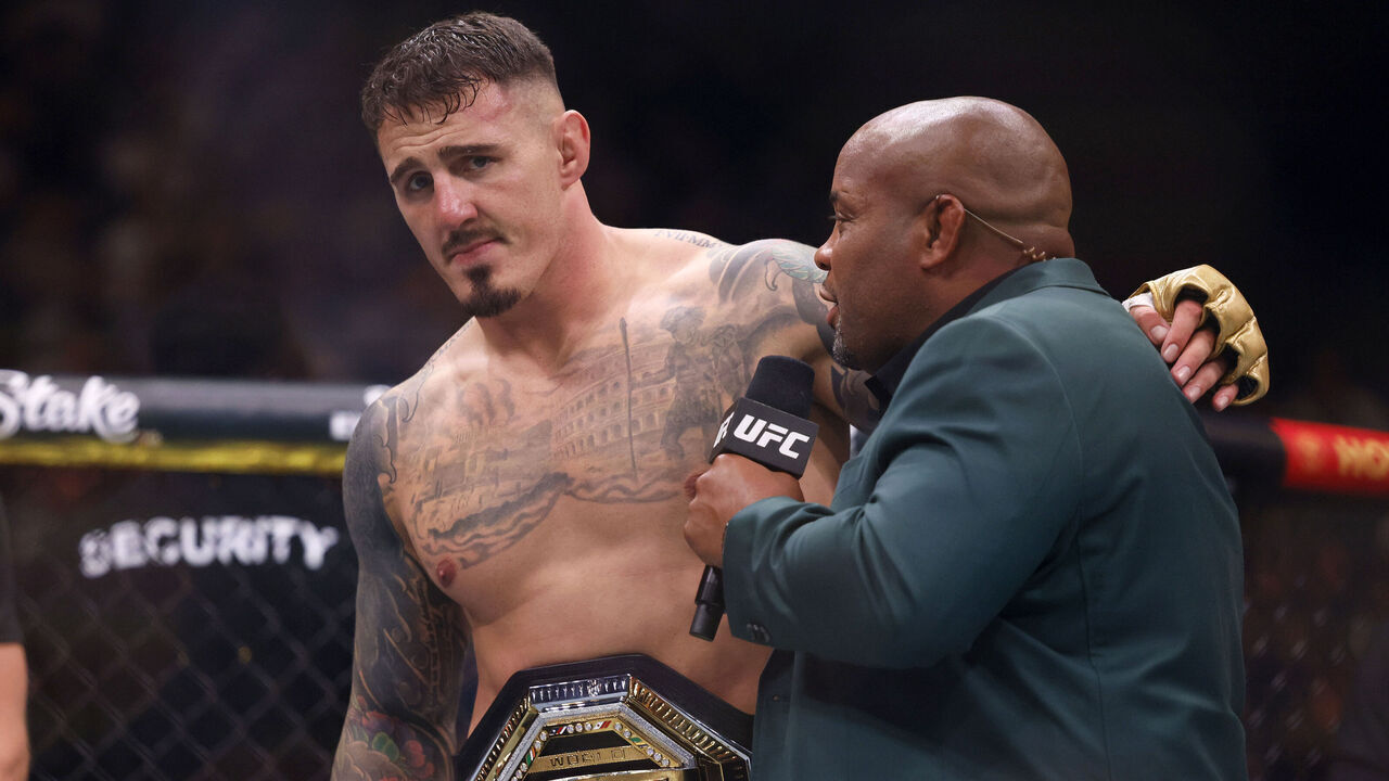 Tom Aspinall left with Daniel Cormier after he beats Curtis Blaydes (not Pictured) in round one during the Heavyweight bout at the Co-op Live Arena, Manchester. Picture date: Saturday July 27, 2024.