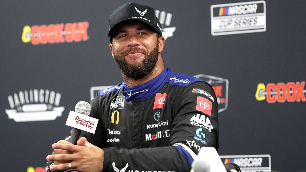 DARLINGTON, SOUTH CAROLINA - AUGUST 31: Bubba Wallace, driver of the #23 U.S. Air Force Toyota, speaks to the media after winning the pole award during qualifying for the NASCAR Cup Series Cook Out Southern 500 at Darlington Raceway on August 31, 2024 in Darlington, South Carolina.