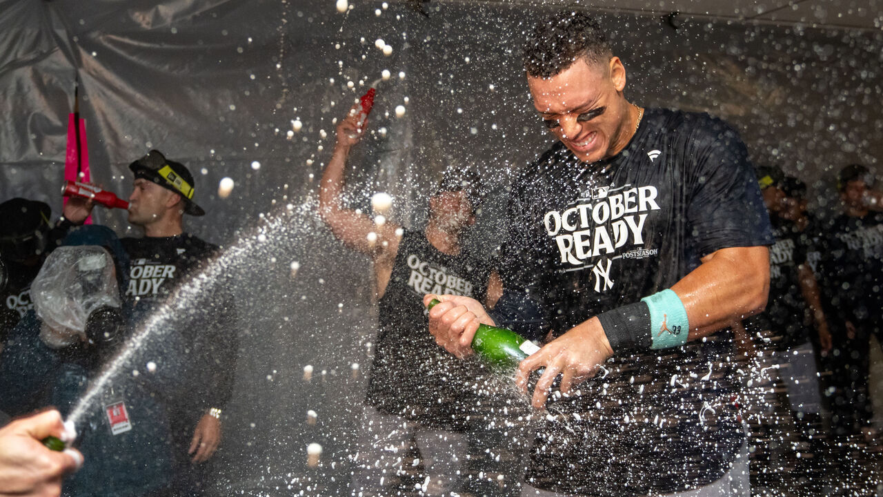 SEATTLE, WA - SEPTEMBER 18: Aaron Judge #99 of the New Yankees celebrates clinching a playoff spot with teammates in the clubhouse after a game against the Seattle Mariners at T-Mobile Park on September 18, 2024 in Seattle, Washington. The Yankees won 2-1 in 10 innings.