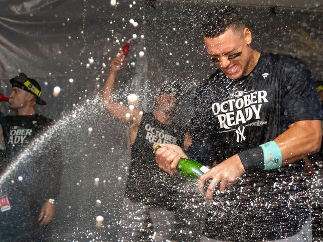 SEATTLE, WA - SEPTEMBER 18: Aaron Judge #99 of the New Yankees celebrates clinching a playoff spot with teammates in the clubhouse after a game against the Seattle Mariners at T-Mobile Park on September 18, 2024 in Seattle, Washington. The Yankees won 2-1 in 10 innings.
