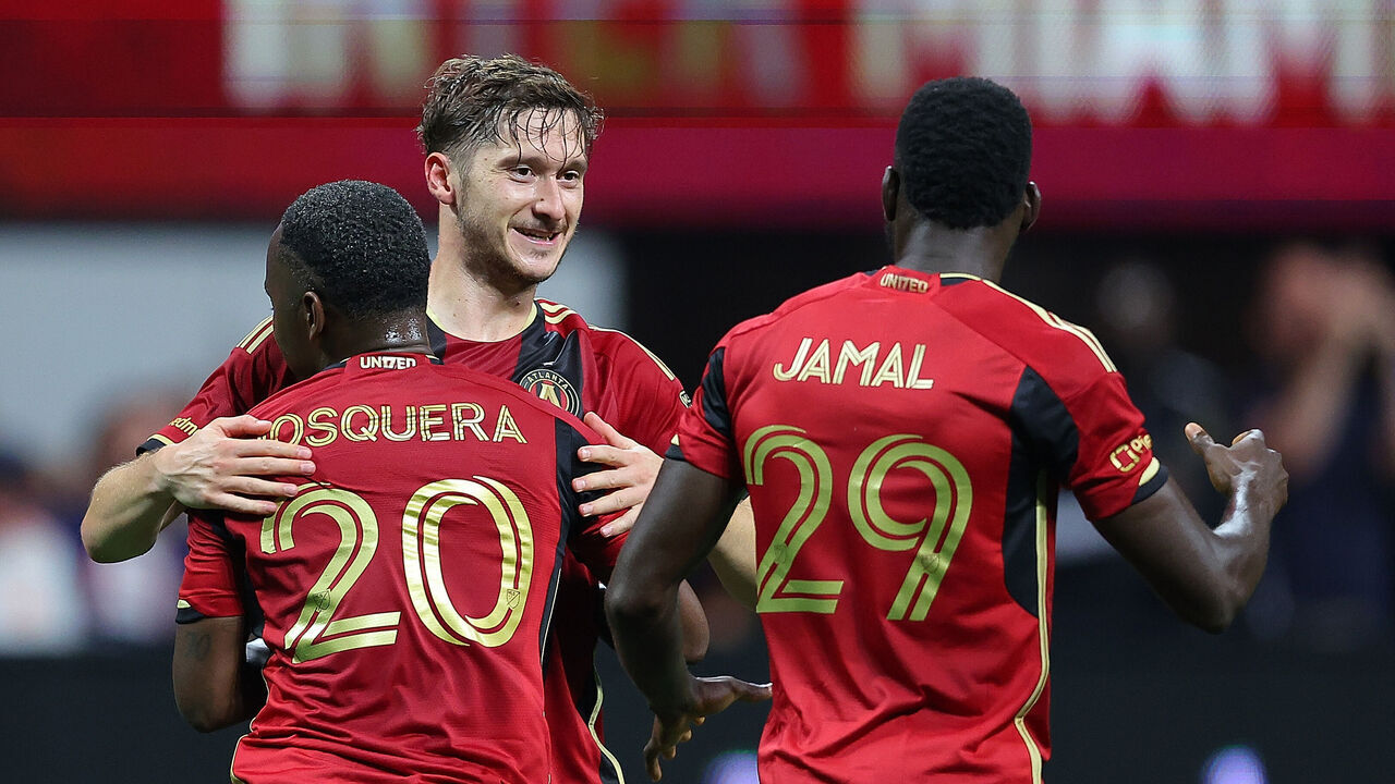 ATLANTA, GEORGIA - SEPTEMBER 18: Aleksei Miranchuk #59 of Atlanta United reacts with Edwin Mosquera #20 and Jamal Thiaré #29 after scoring a goal against Inter Miami during the second half at Mercedes-Benz Stadium on September 18, 2024 in Atlanta, Georgia.