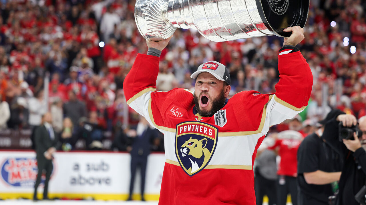 SUNRISE, FLORIDA - JUNE 24: Kyle Okposo #8 of the Florida Panthers hoists the Stanley Cup after Florida's 2-1 victory against the Edmonton Oilers in Game Seven of the 2024 Stanley Cup Final at Amerant Bank Arena on June 24, 2024 in Sunrise, Florida.