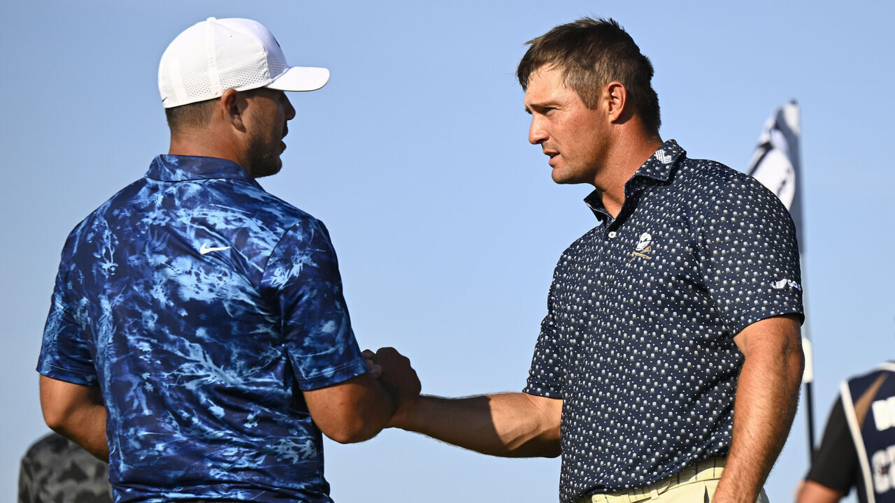 BOLINGBROOK, ILLINOIS - SEPTEMBER 13: (L-R) Brooks Koepka of the Smash GC and Bryson DeChambeau of the Crushers GC shake hands after day one of LIV Golf: Chicago at Bolingbrook Golf Club on September 13, 2024 in Bolingbrook, Illinois.