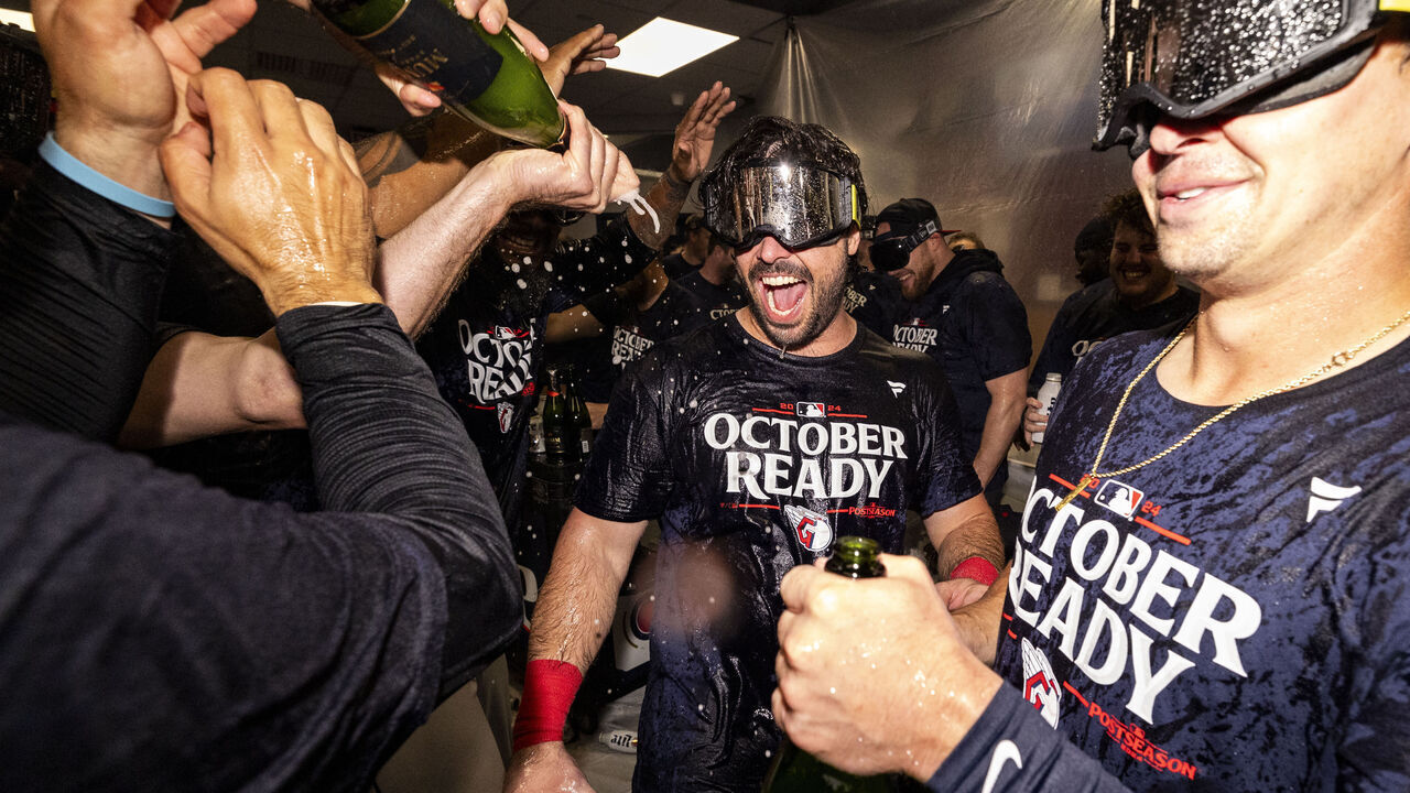 CLEVELAND, OHIO - SEPTEMBER 19: Austin Hedges #27 of the Cleveland Guardians celebrates in the clubhouse after the Guardians beat the Minnesota Twins 3-2 to clinch a playoff spot at Progressive Field on September 19, 2024 in Cleveland, Ohio.