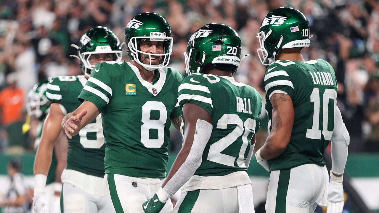 EAST RUTHERFORD, NEW JERSEY - SEPTEMBER 19: Aaron Rodgers #8 and Breece Hall #20 of the New York Jets celebrate a touchdown against the New England Patriots during the third quarter in the game at MetLife Stadium on September 19, 2024 in East Rutherford, New Jersey.