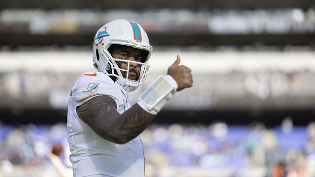 BALTIMORE, MARYLAND - DECEMBER 31: Tua Tagovailoa #1 of the Miami Dolphins signals as he warms up prior to an NFL football game between the Baltimore Ravens and the Miami Dolphins at M&T Bank Stadium on December 31, 2023 in Baltimore, Maryland.