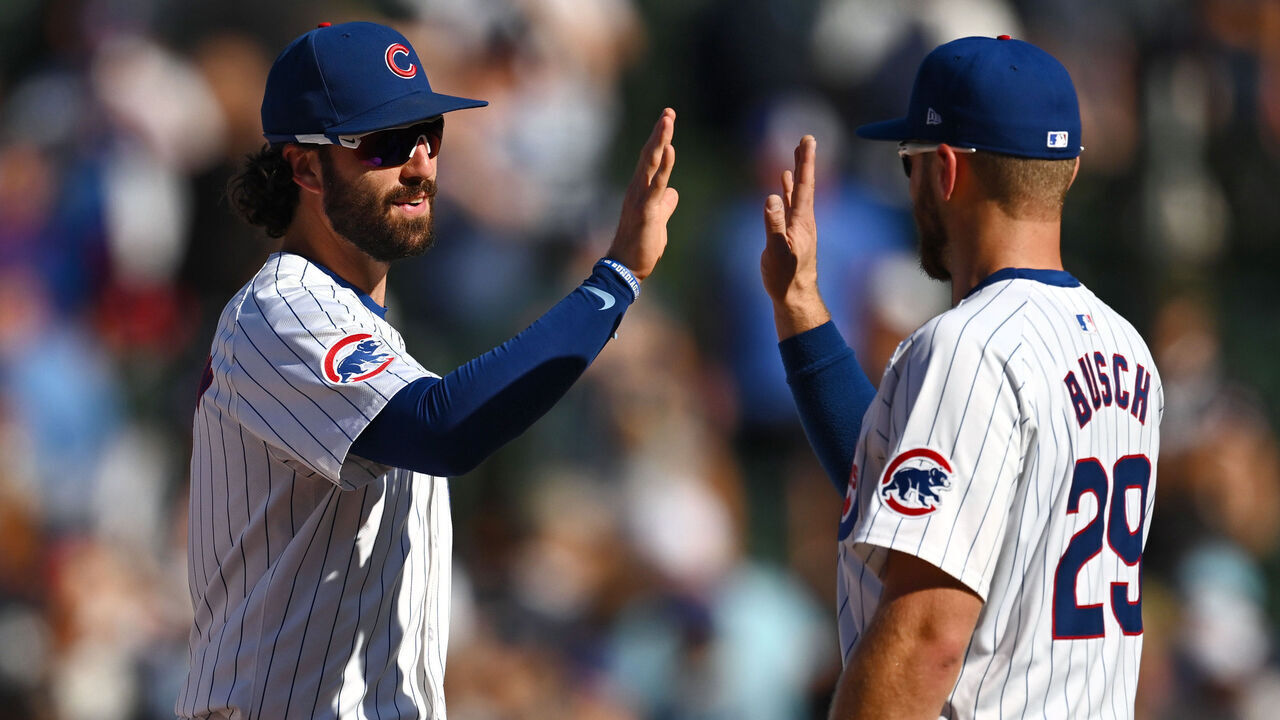 CHICAGO, ILLINOIS - SEPTEMBER 20: Dansby Swanson #7 and Michael Busch #29 of the Chicago Cubs celebrate the 3-1 win against the Washington Nationals at Wrigley Field on September 20, 2024 in Chicago, Illinois.