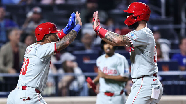 NEW YORK, NEW YORK - SEPTEMBER 20: (L-R) Edmundo Sosa #33 and Weston Wilson #37 of the Philadelphia Phillies high five after scoring during the fourth inning of the game against the New York Mets at Citi Field on September 20, 2024 in New York City.