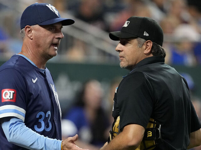 KANSAS CITY, MISSOURI - SEPTEMBER 20: Manager Matt Quatraro #33 of the Kansas City Royals talks with plate umpire James Hoye in the sixth inning during the game between the San Francisco Giants and the Kansas City Royals at Kauffman Stadium on September 20, 2024 in Kansas City, Missouri.
