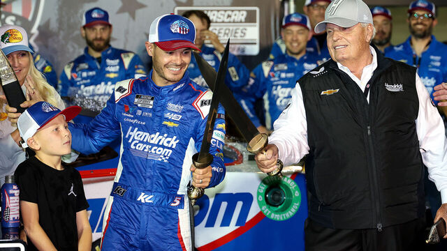 BRISTOL, TENNESSEE - SEPTEMBER 21: NASCAR Hall of Famer and Hendrick Motorsport team owner, Rick Hendrick (R) celebrates with Kyle Larson, driver of the #5 HendrickCars.com Chevrolet, and his son, Owen Larson in victory lane after winning the NASCAR Cup Series Bass Pro Shops Night Race at Bristol Motor Speedway on September 21, 2024 in Bristol, Tennessee.