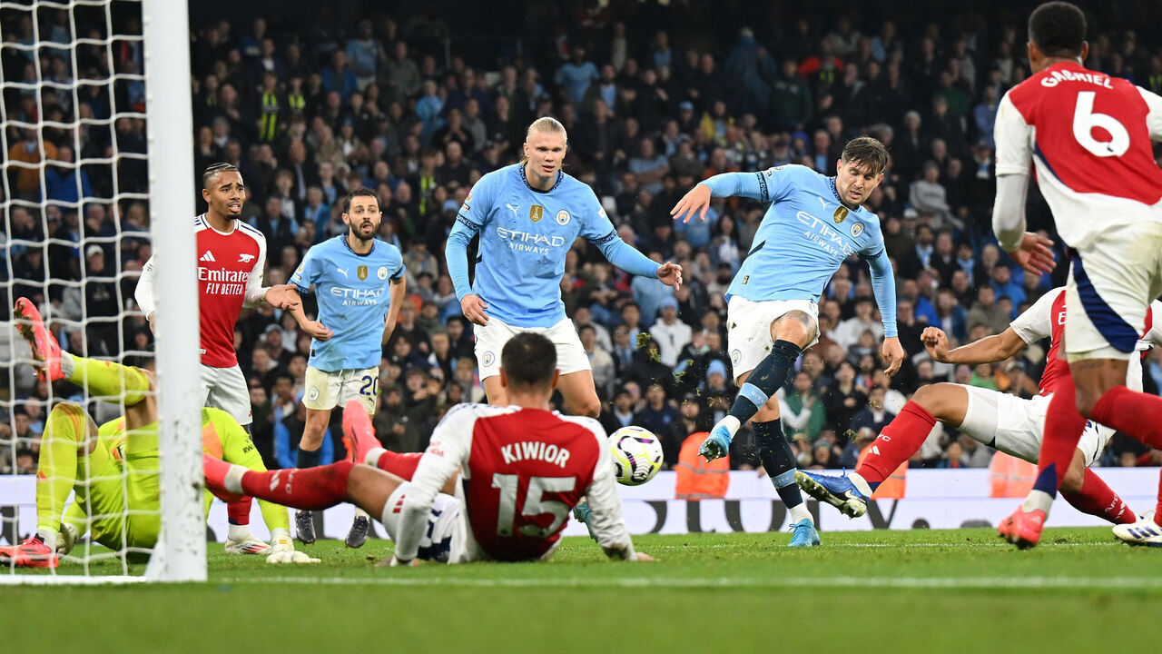MANCHESTER, ENGLAND - SEPTEMBER 22: John Stones of Manchester City scores his team's second goal during the Premier League match between Manchester City FC and Arsenal FC at Etihad Stadium on September 22, 2024 in Manchester, England.