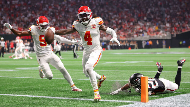 ATLANTA, GEORGIA - SEPTEMBER 22: Rashee Rice #4 of the Kansas City Chiefs scores a touchdown while defended by Dee Alford #20 of the Atlanta Falcons during the second quarter at Mercedes-Benz Stadium on September 22, 2024 in Atlanta, Georgia.