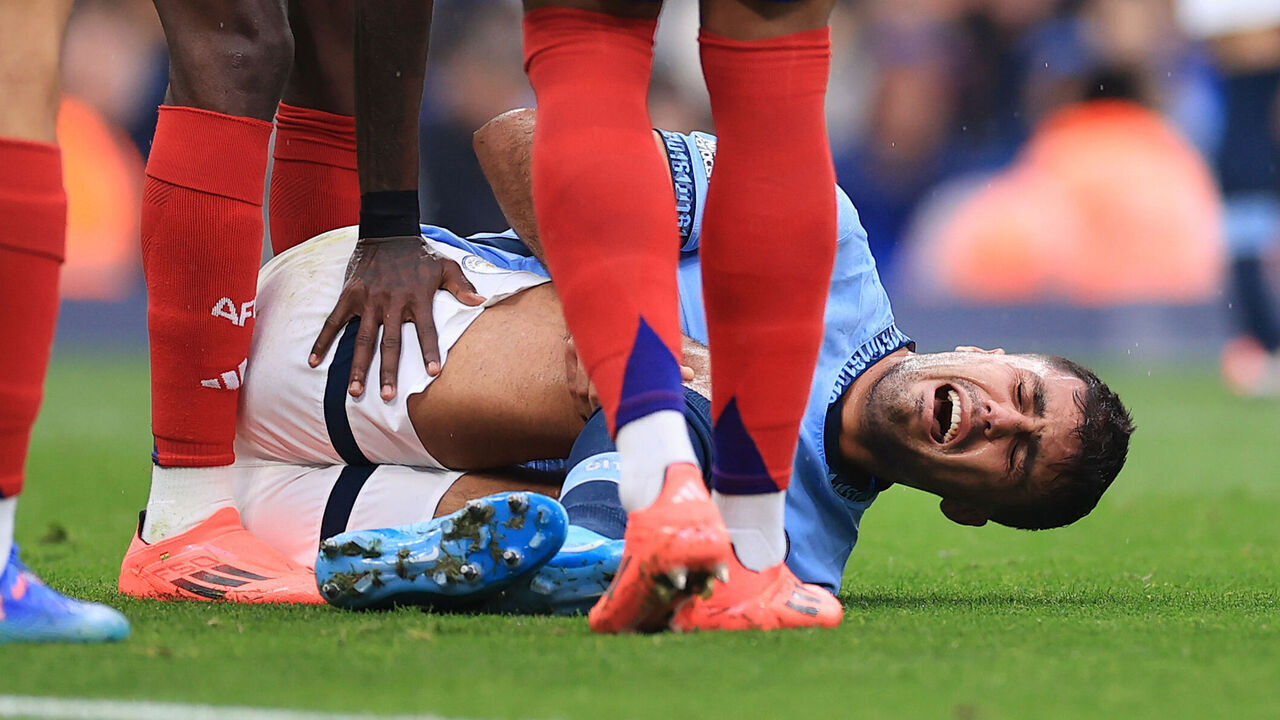 MANCHESTER, ENGLAND - SEPTEMBER 22: Rodri of Manchester City lies injured during the Premier League match between Manchester City FC and Arsenal FC at Etihad Stadium on September 22, 2024 in Manchester, England.
