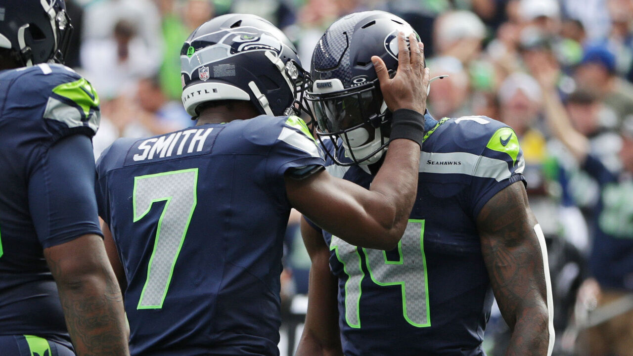 SEATTLE, WASHINGTON - SEPTEMBER 22: DK Metcalf #14 celebrates with Geno Smith #7 of the Seattle Seahawks after a touchdown during the first quarter against the Miami Dolphins at Lumen Field on September 22, 2024 in Seattle, Washington.