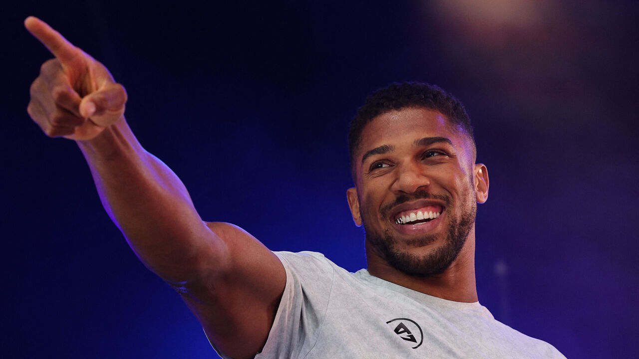 Britain's Anthony Joshua gestures as he arrives on stage for a public weigh-in in Trafalgar Square on September 20, 2024 on the eve of a heavyweight boxing match for the IBF world title in London. Daniel Dubois says he has to justify his status as IBF world heavyweight champion by showing he is the coming force in British boxing against Anthony Joshua at a sold-out Wembley on Saturday. The pair will battle it out in front of a reported post-war British record crowd of 96,000. Dubois won the interim IBF title in June and was elevated to world champion status when Oleksandr Usyk vacated.