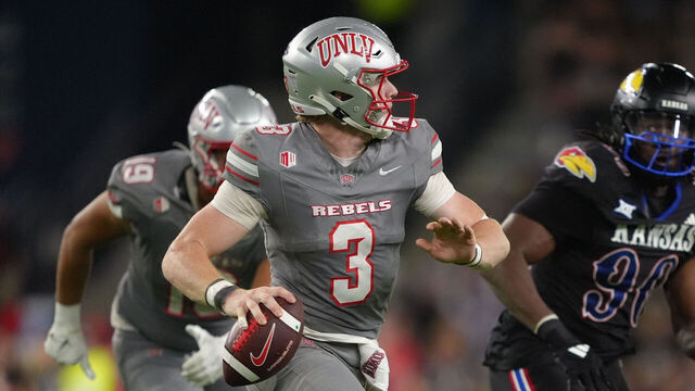 KANSAS CITY, KANSAS - SEPTEMBER 14: Quarterback Matthew Sluka #3 of the UNLV Rebels avoids defensive end Jereme Robinson #90 of the Kansas Jayhawks during the fourth quarter at Childrens Mercy Park on September 13, 2024 in Kansas City, Kansas.