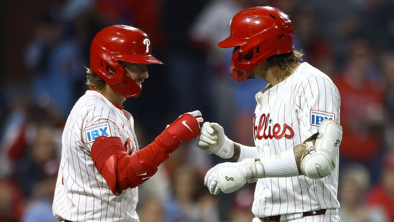 PHILADELPHIA, PENNSYLVANIA - SEPTEMBER 25: Bryson Stott #5 and Nick Castellanos #8 of the Philadelphia Phillies react following a home run by Castellanos during the third inning against the Chicago Cubs at Citizens Bank Park on September 25, 2024 in Philadelphia, Pennsylvania.