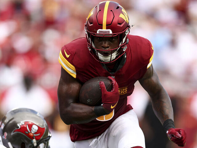TAMPA, FL - SEPTEMBER 8: Brian Robinson Jr. #8 of the Washington Commanders carries the ball during an NFL football game against the Tampa Bay Buccaneers at Raymond James Stadium on September 8, 2024 in Tampa, Florida.