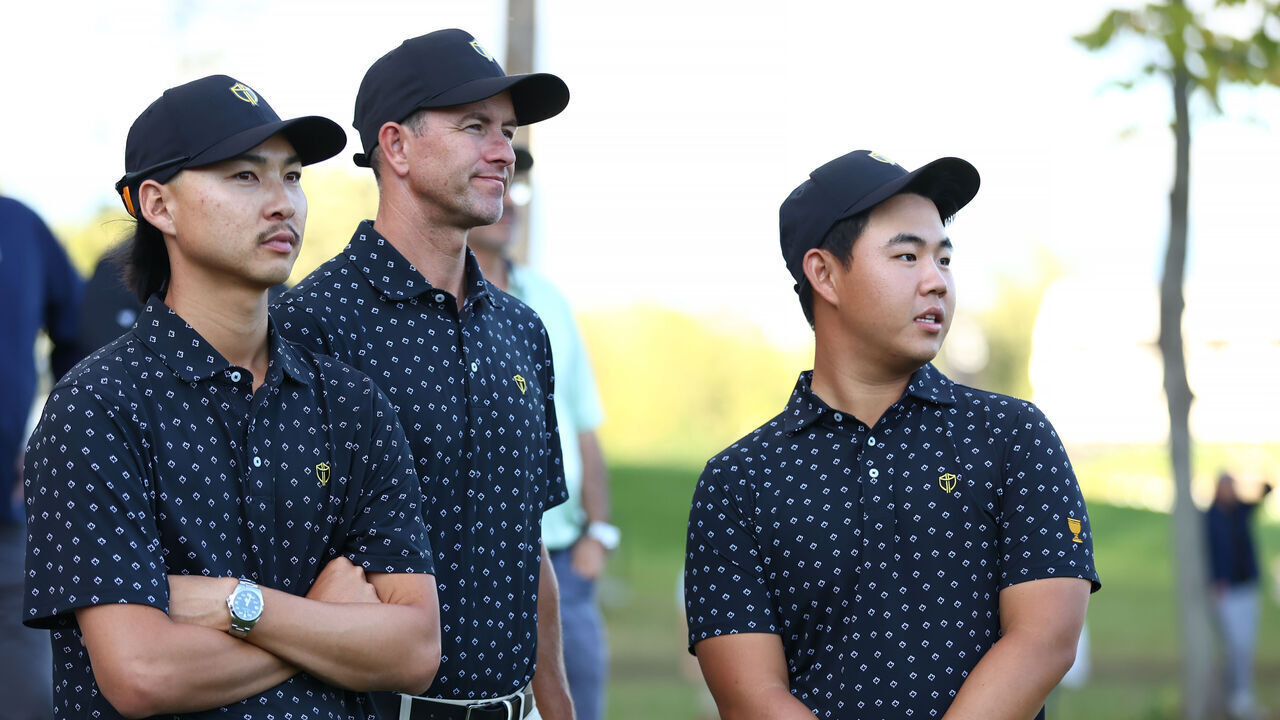 MONTREAL, QUEBEC - SEPTEMBER 26: Min Woo Lee of Australia, Adam Scott of Australia, and Tom Kim of South Korea and the International Team look on during Thursday's Four-ball matches on day one of the 2024 Presidents Cup at The Royal Montreal Golf Club on September 26, 2024 in Montreal, Quebec, Canada.
