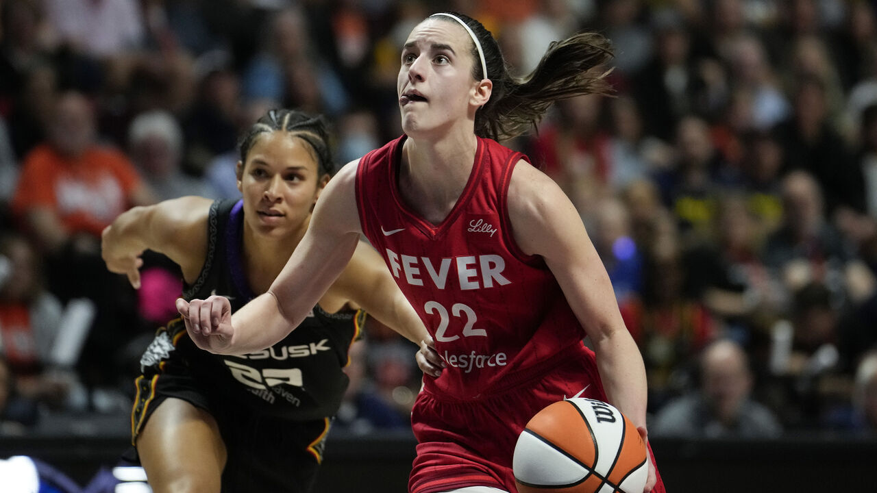 UNCASVILLE, CONNECTICUT - SEPTEMBER 25: Caitlin Clark #22 of the Indiana Fever drives against Veronica Burton #22 of the Connecticut Sun during the third quarter of Game Two of the 2024 WNBA Playoffs first round at Mohegan Sun Arena on September 25, 2024 in Uncasville, Connecticut.