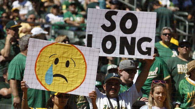 OAKLAND, CA - SEPTEMBER 26: Fans hold up signs prior to the game between the Texas Rangers and the Oakland Athletics at RingCentral Coliseum on Thursday, September 26, 2024 in Oakland, California.