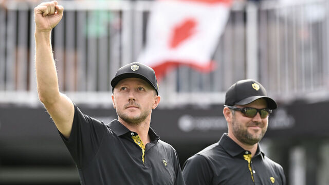 MONTREAL, QUEBEC - SEPTEMBER 27: Mackenzie Hughes and Corey Conners of the International Team react to the crowd on the first tee during Friday's Foursomes matches on day two of the 2024 Presidents Cup at The Royal Montreal Golf Club on September 27, 2024 in Montreal, Quebec.