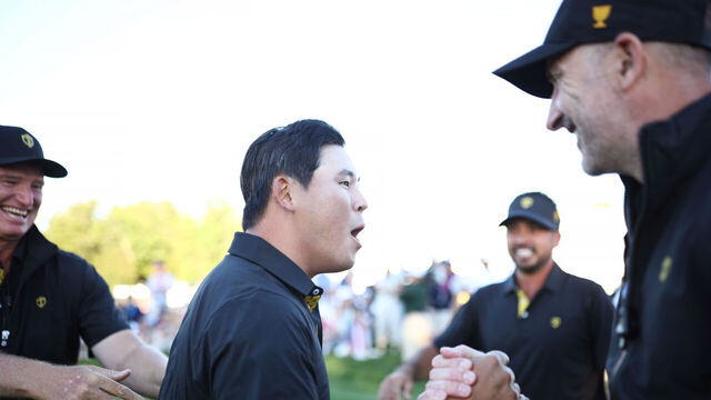 MONTREAL, QUEBEC - SEPTEMBER 27: Si Woo Kim of South Korea and International Team Captain Mike Weir celebrate on the 18th green during Friday Foursomes on day two of the 2024 Presidents Cup at The Royal Montreal Golf Club on September 27, 2024 in Montreal, Quebec, Canada.