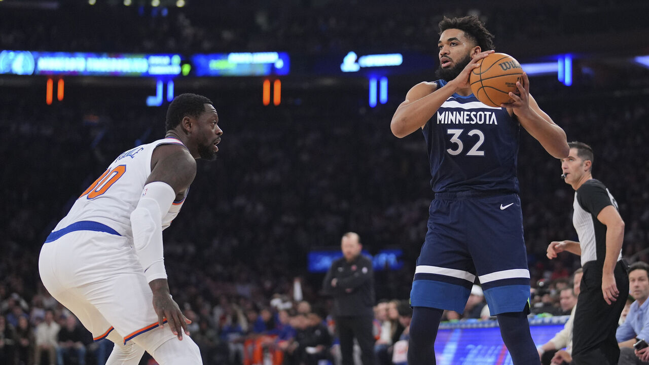 NEW YORK, NEW YORK - JANUARY 1: Karl-Anthony Towns #32 of the Minnesota Timberwolves controls the ball against Julius Randle #30 of the New York Knicks at Madison Square Garden on January 1, 2024 in New York City. The Knicks defeated the Timberwolves 112-106.